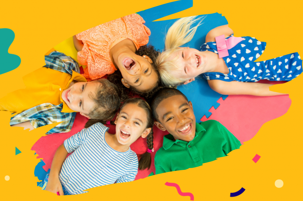 On a yellow background with colourful multicoloured illustrated shapes, a photo of five smiling children lying down with their heads together in the centre.